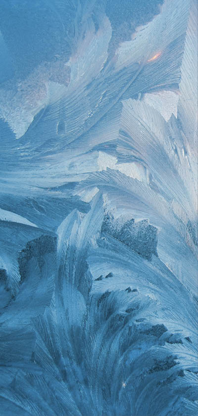 frosty natural pattern and sun on winter window