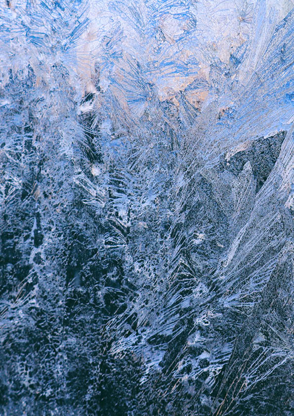 Ice patterns on window lit by the sunrise light.