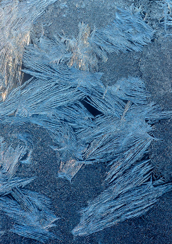 Texture of ice with blue back light. Abstract background
