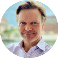 A man with a beard and mustache wearing a blue shirt. Description generated by AI
