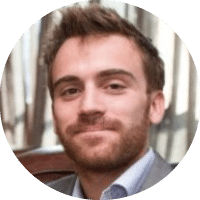 A man with a beard and mustache wearing a suit and tie. Description generated by AI