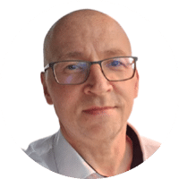 A bald man wearing glasses. Description generated by AI