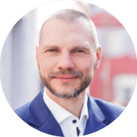A man wearing a blue suit and white shirt. Description generated by AI