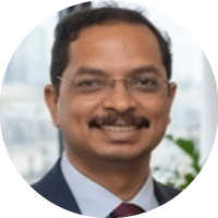 A man wearing a blue suit and a red tie. Description generated by AI