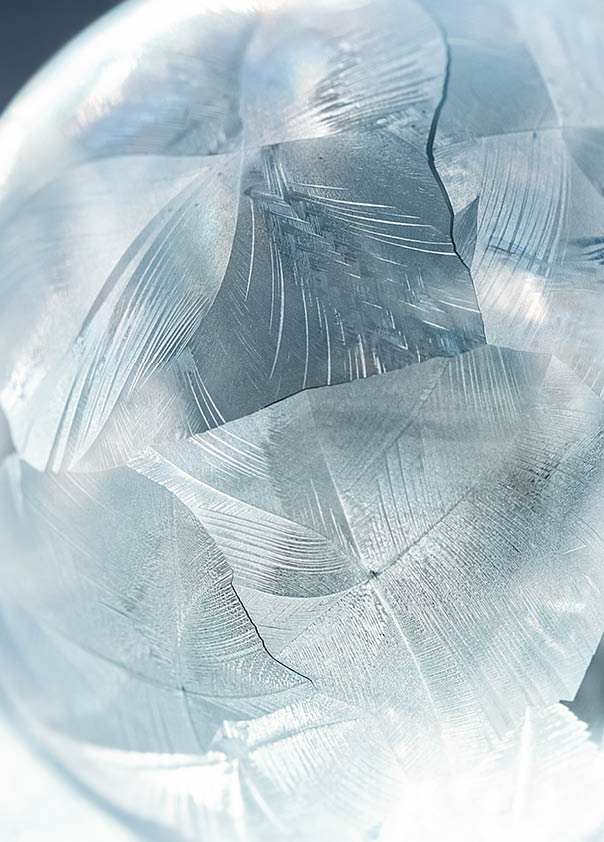 frozen bubble with bokeh background. Beautiful frosty patterns on frozen soap bubble. winter, frosty background. Macro photo