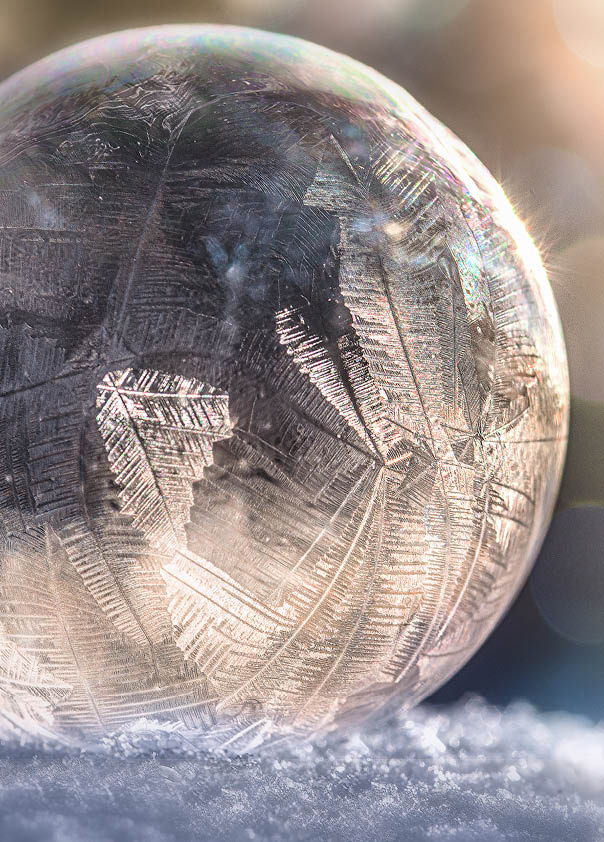 Frozen soap bubble with a unique pattern created by frost