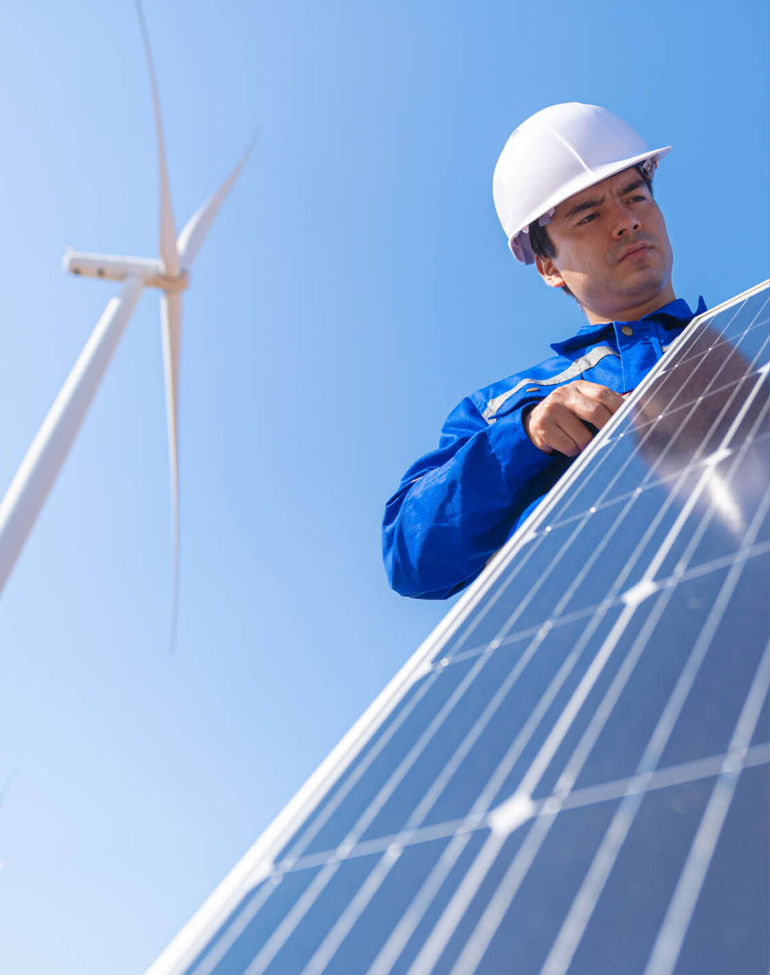 A man wearing a hard hat is working on a solar panel. AI generated content
