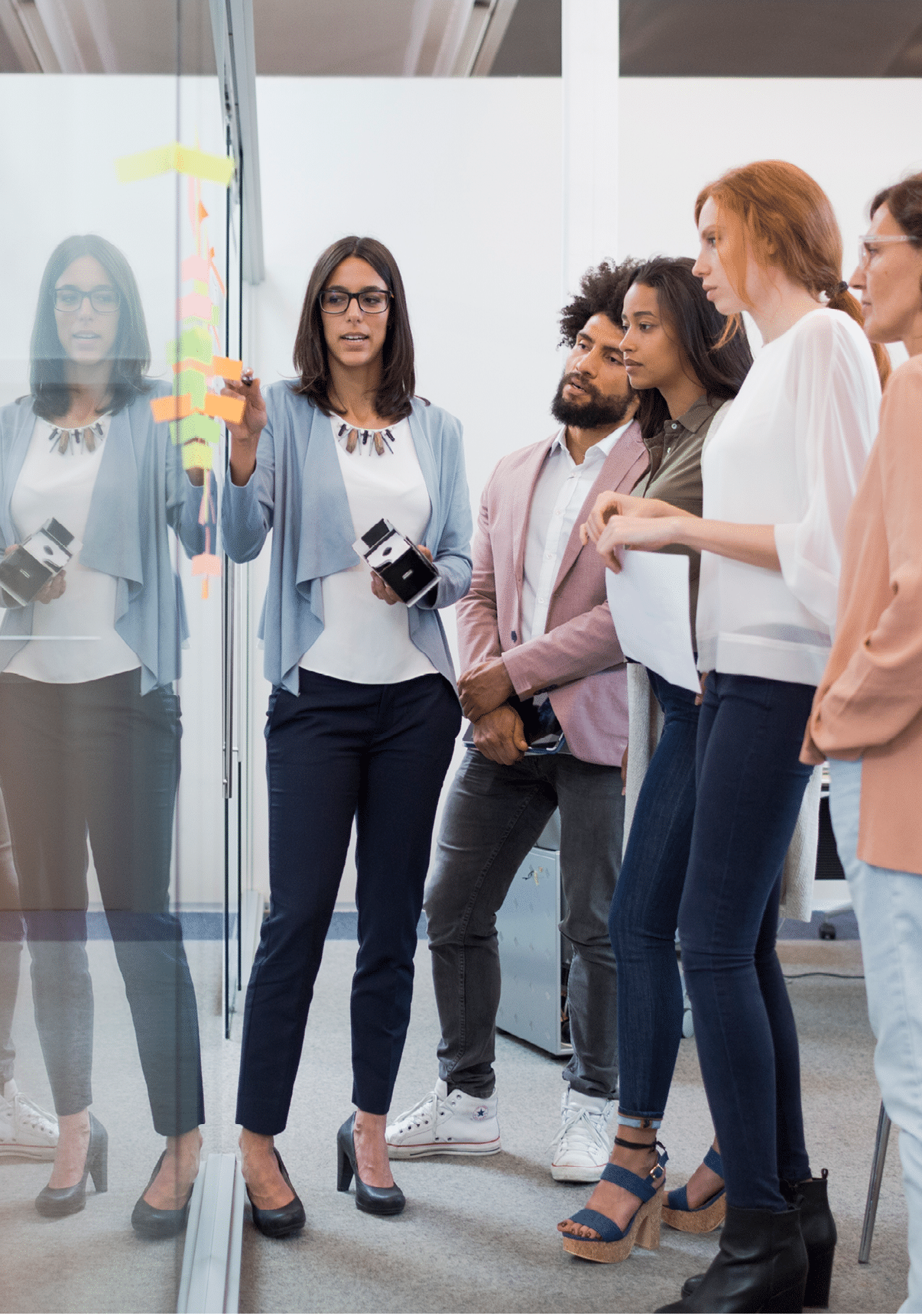 Business people brainstorming in conference room with adhesive notes 