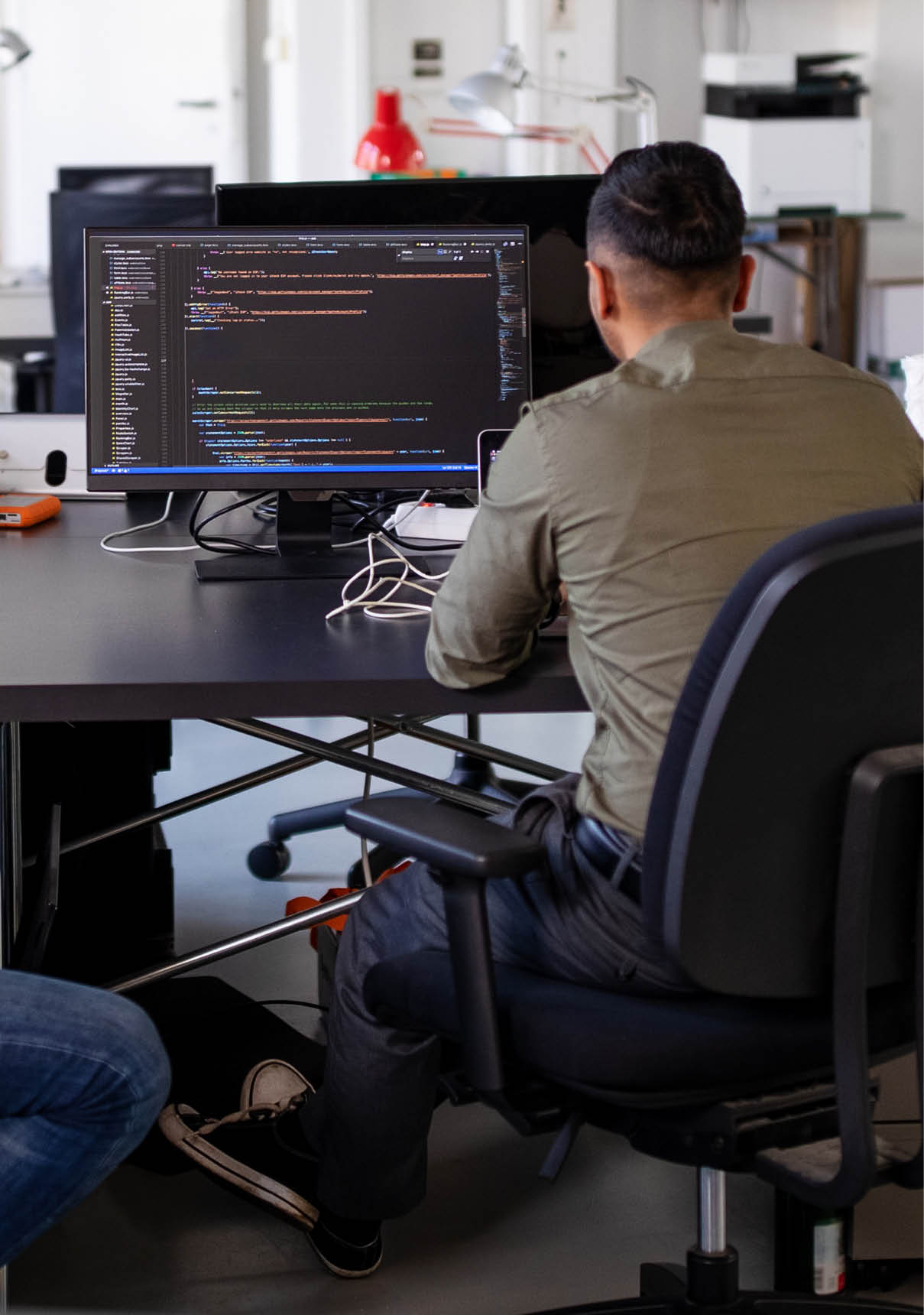 Rear view of two computer programmer working on a new project  Web designers working on new computer program in modern office 