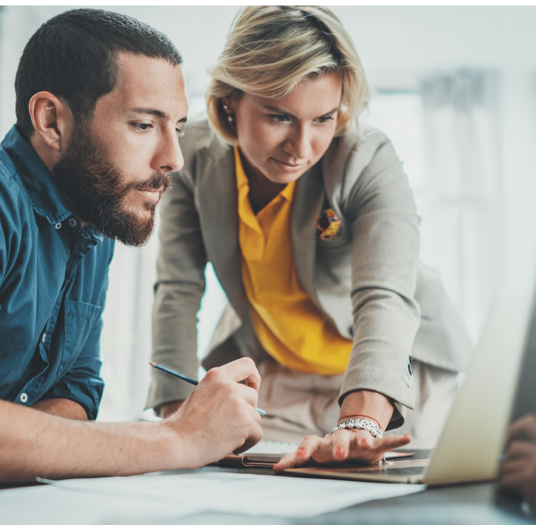 Working process photo Two young coworkers working together at modern office loft