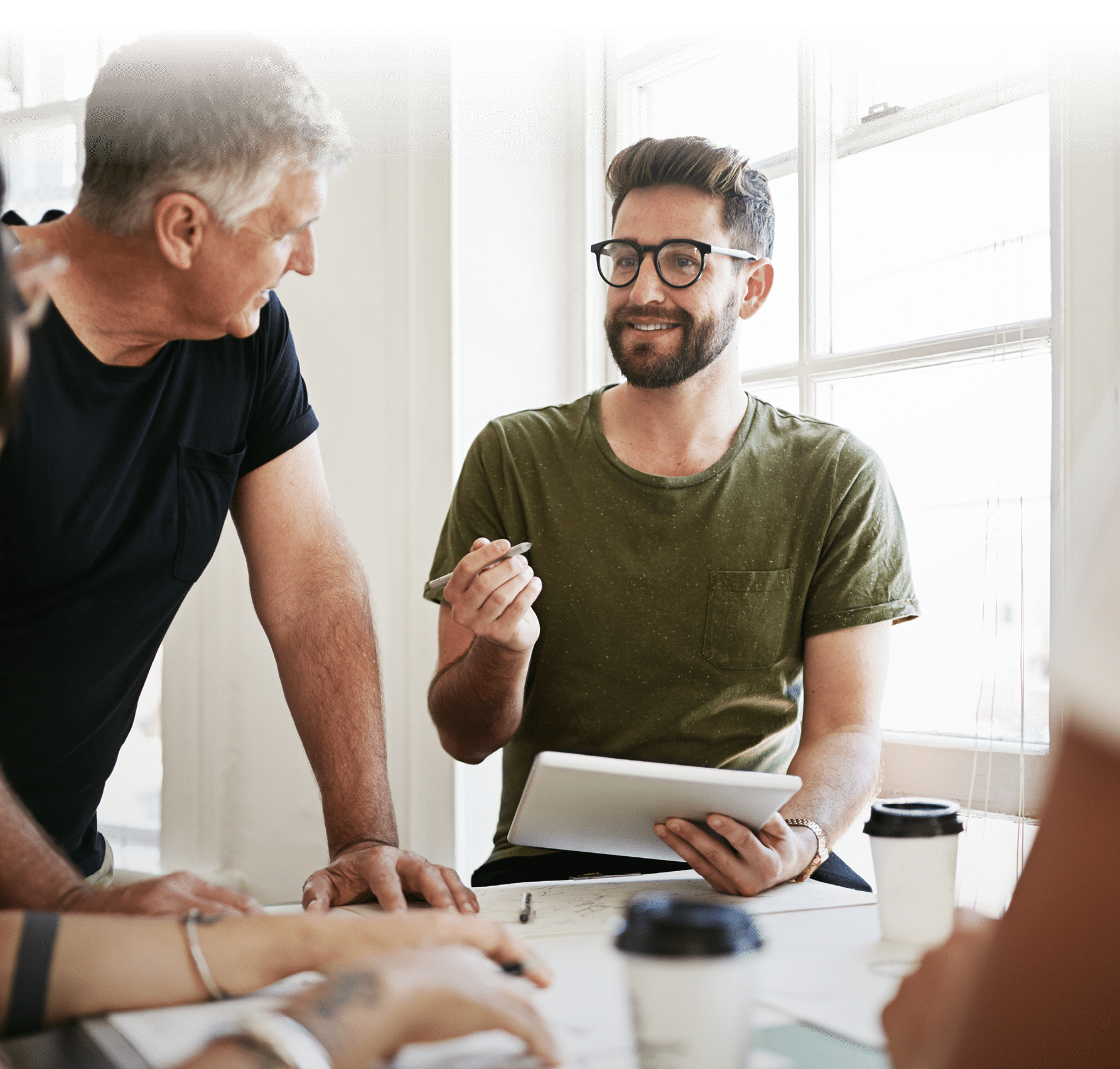Shot of a group of designers using a tablet while brainstorming in the office
