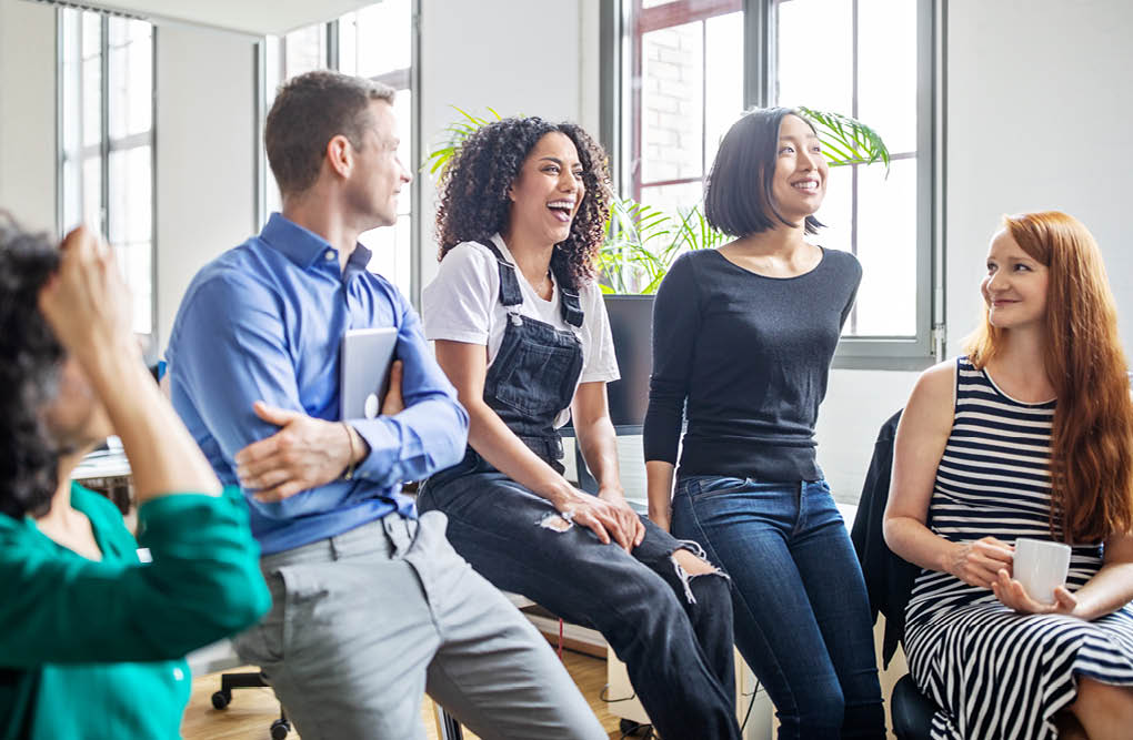 Cheerful multi-ethnic business colleagues in meeting  Male and female professionals laughing during a meeting 